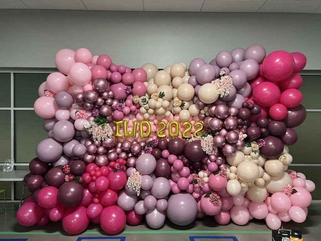 A festive balloon table centerpiece made of balloons and ribbon.