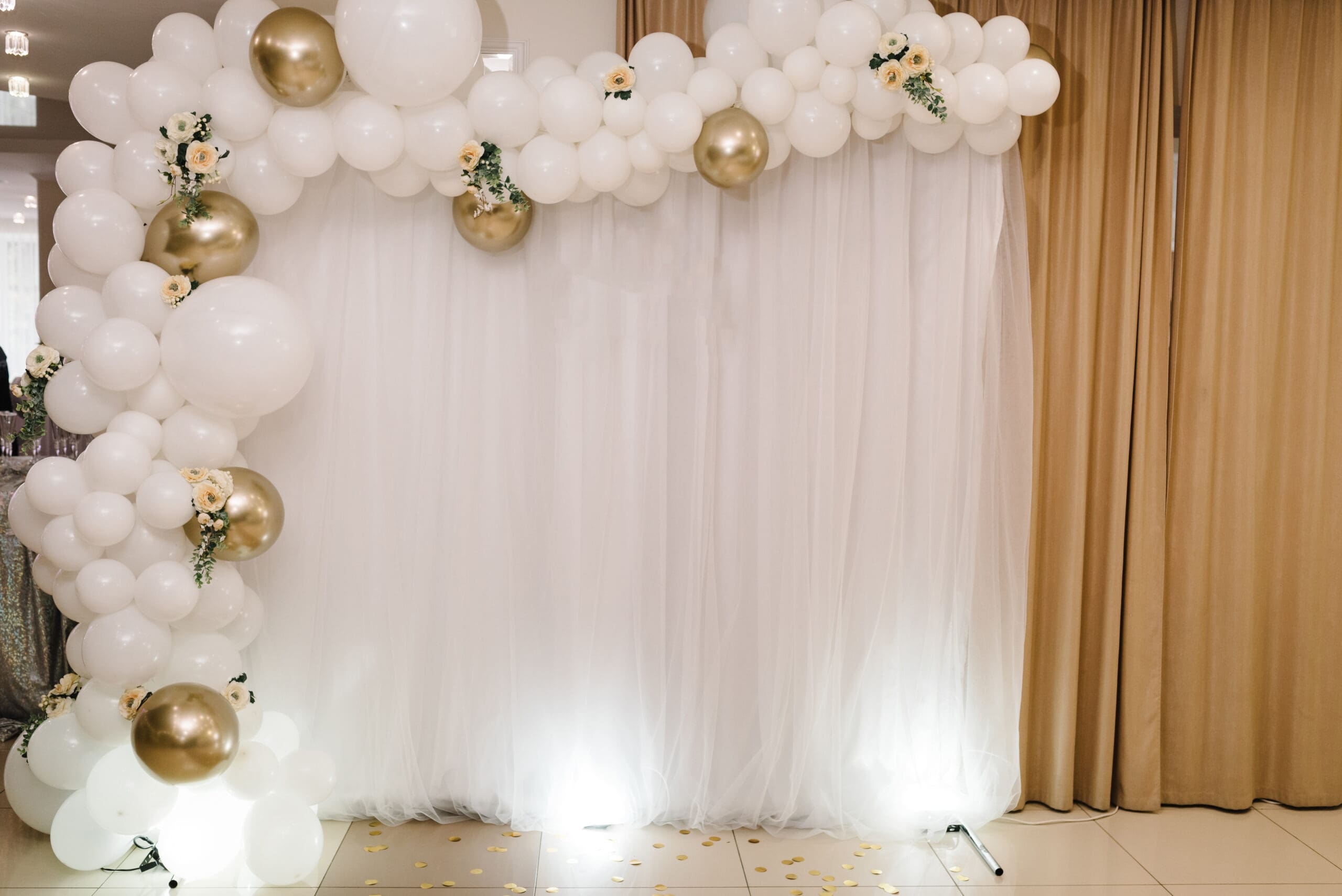 Wedding reception. Arch on a background balloons, party decor. Copy space. Celebration concept. Photo-wall, wedding decoration space or place from white and gold balloons and flowers. Autumn decor.